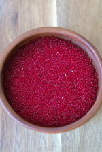 Load image into Gallery viewer, Transparent Ruby Charlotte Beads 11/0
